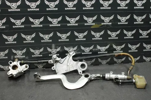 1999 SUZUKI RM250 OEM REAR BACK BRAKE CALIPER MASTER CYLINDER LEVER NEEDS WORK!