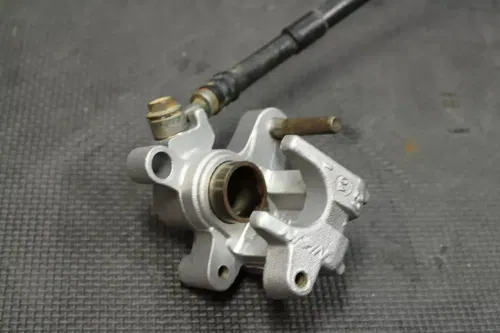 1999 SUZUKI RM250 OEM REAR BACK BRAKE CALIPER MASTER CYLINDER LEVER NEEDS WORK!