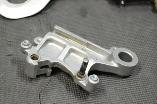 1999 SUZUKI RM250 OEM REAR BACK BRAKE CALIPER MASTER CYLINDER LEVER NEEDS WORK!