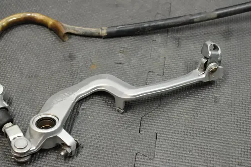 1999 SUZUKI RM250 OEM REAR BACK BRAKE CALIPER MASTER CYLINDER LEVER NEEDS WORK!