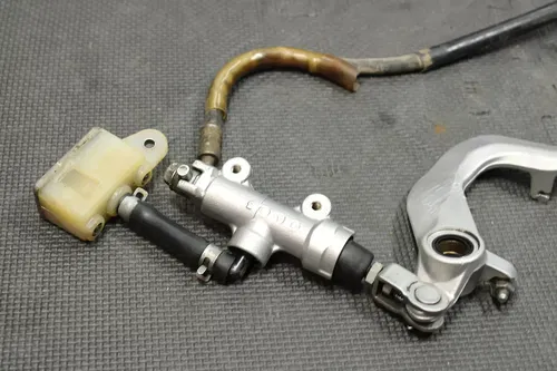 1999 SUZUKI RM250 OEM REAR BACK BRAKE CALIPER MASTER CYLINDER LEVER NEEDS WORK!