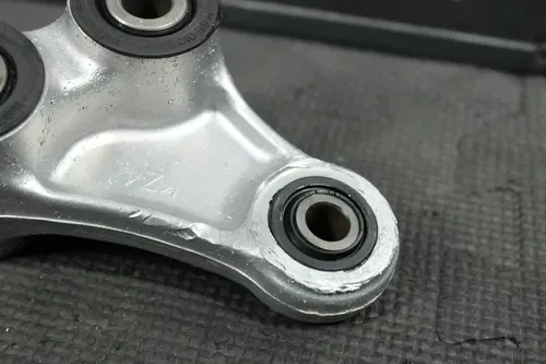 1990 HONDA CR125R OEM REAR DOGBONE SHOCK LINKAGE LINK ARM 52460-KZ4-020