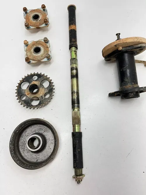 02 2002 Polaris Scrambler 90 2x4 2T OEM Rear Axle Hubs Brake Bracket Carrier