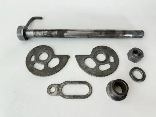 OEM 1985 85 HONDA XR250R XR 250 R REAR WHEEL AXLE W SPACER & CHAIN ADJUSTERS