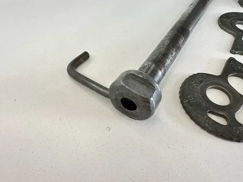 OEM 1985 85 HONDA XR250R XR 250 R REAR WHEEL AXLE W SPACER & CHAIN ADJUSTERS
