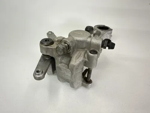 USED OEM 2004 04 2005 05 KAWASAKI KX250F REAR BRAKE CALIPER & MOUNT ASSY