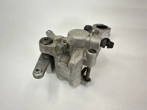 USED OEM 2004 04 2005 05 KAWASAKI KX250F REAR BRAKE CALIPER & MOUNT ASSY