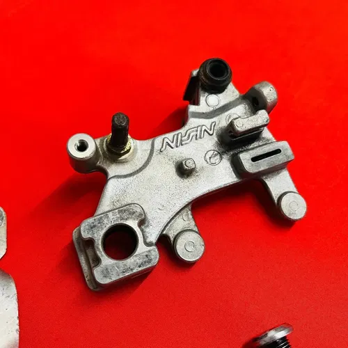 CR85 REAR BRAKE CALIPER MOUNT BRACKET GENUINE OEM HONDA CR 85 R RB (2003-2008)