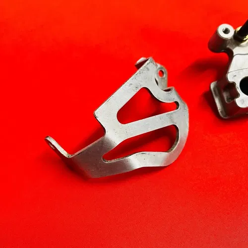 CR85 REAR BRAKE CALIPER MOUNT BRACKET GENUINE OEM HONDA CR 85 R RB (2003-2008)