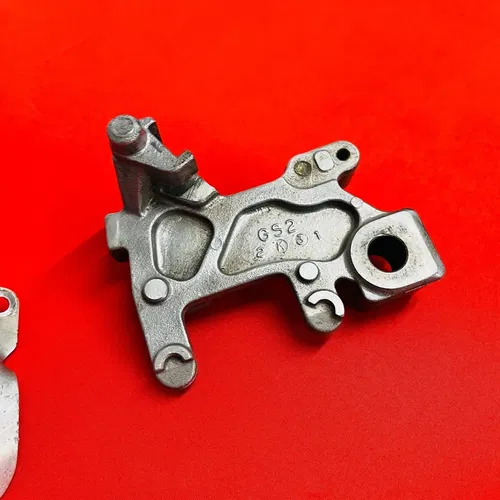 CR85 REAR BRAKE CALIPER MOUNT BRACKET GENUINE OEM HONDA CR 85 R RB (2003-2008)