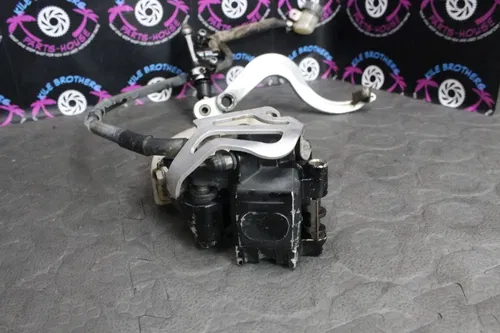 1987 Honda CR125R OEM REAR BACK BRAKE CALIPER  MASTER CYLINDER PEDAL